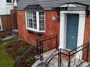 custom wrought iron handrail matching canopy with custom cut address in metal canopy Toronto area image